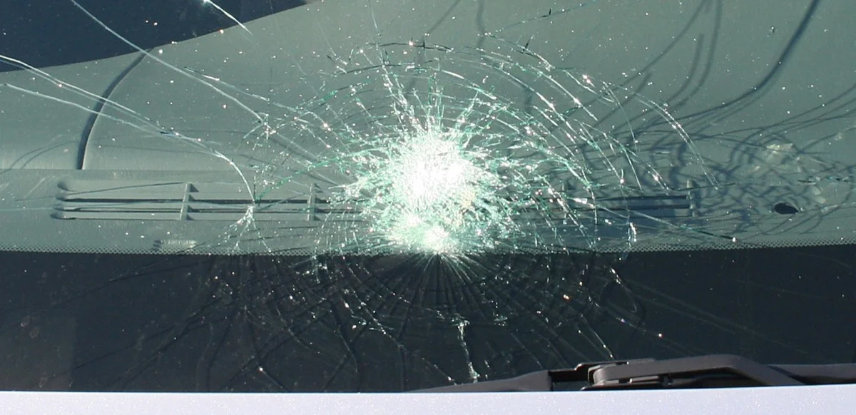 Windshield with spider web crack damage covered by insurance